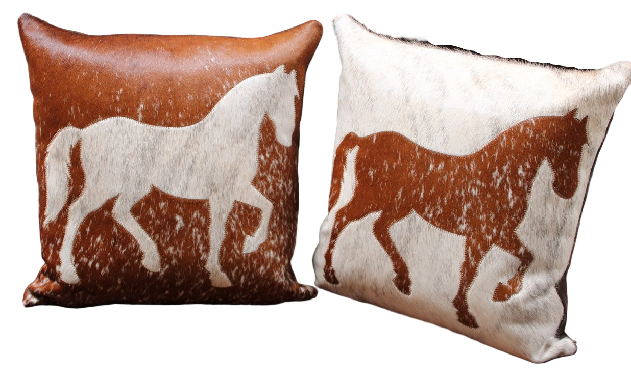 Two pillows with horse designs on a wooden surface