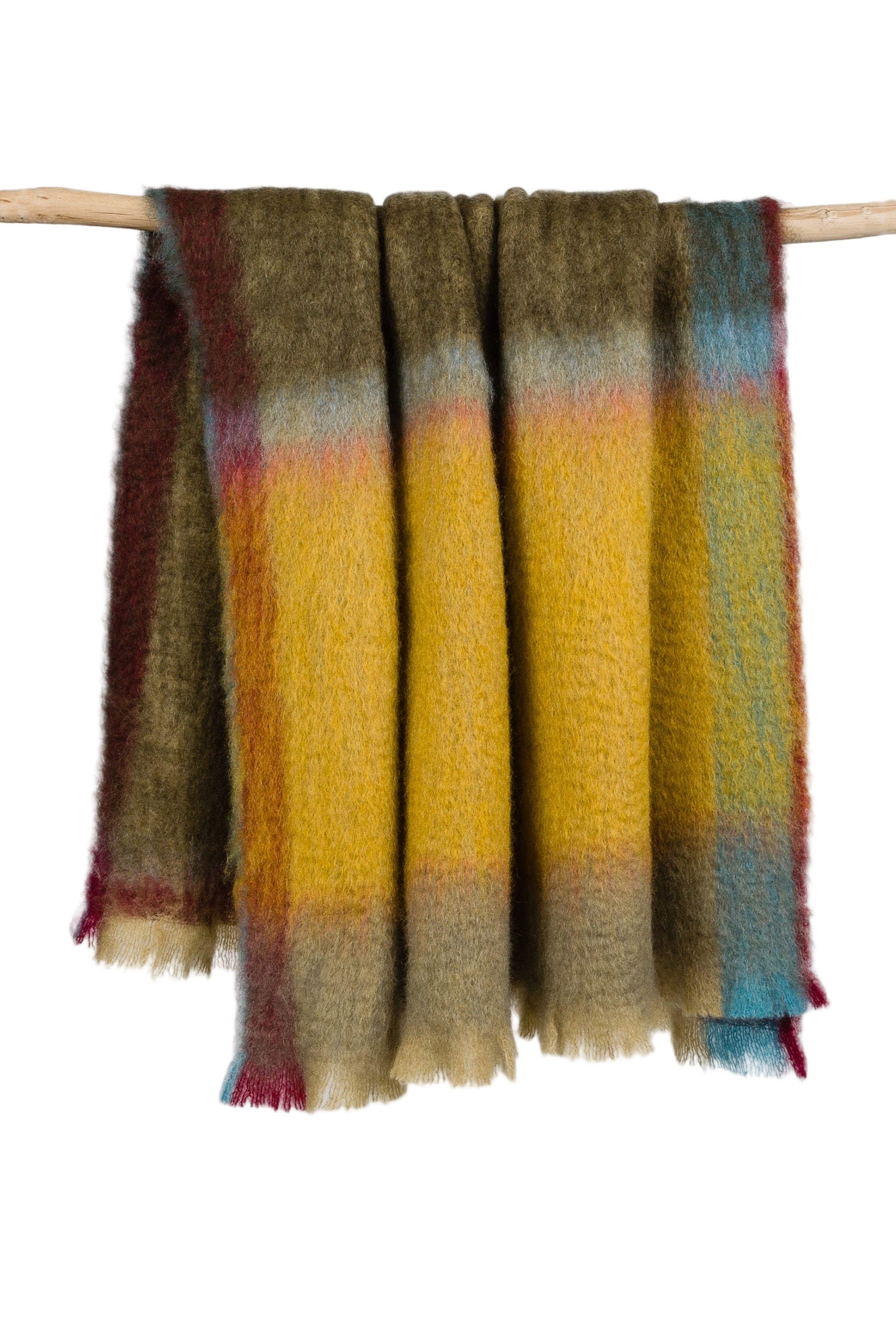 Multicolored plaid blanket draped over a wooden stick on a white background