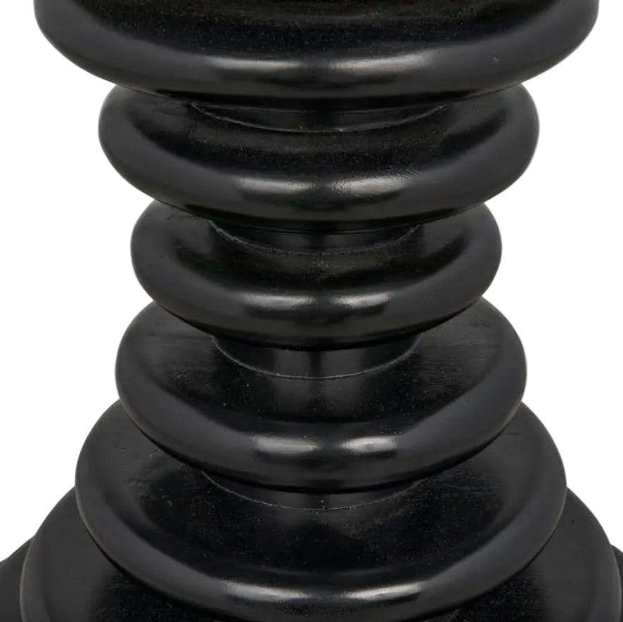 Close-up of a black decorative vase with layered design on a white background